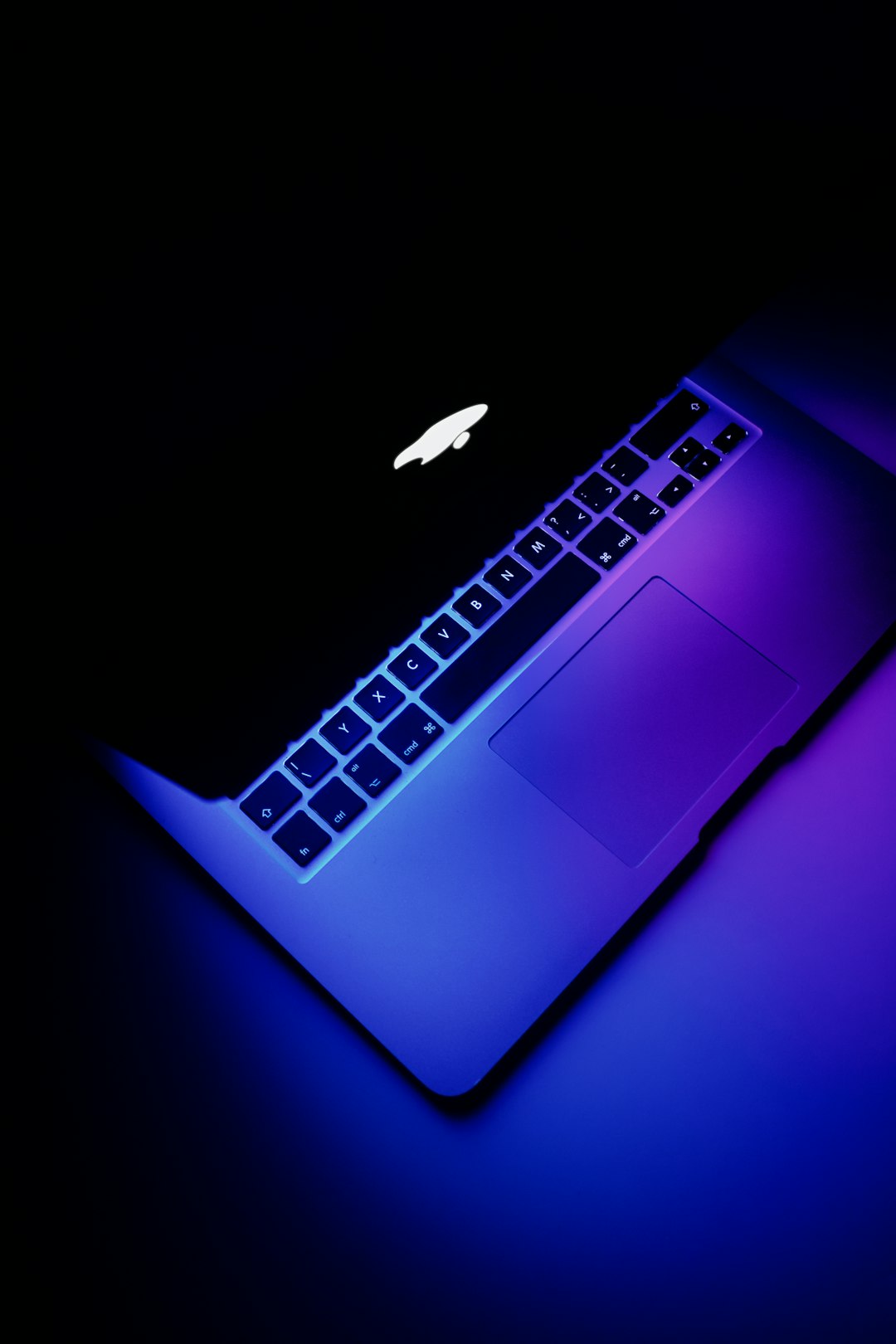 Apple MacBook in neon dark colors.